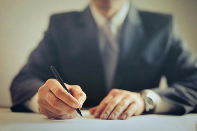 man in suit sitting down