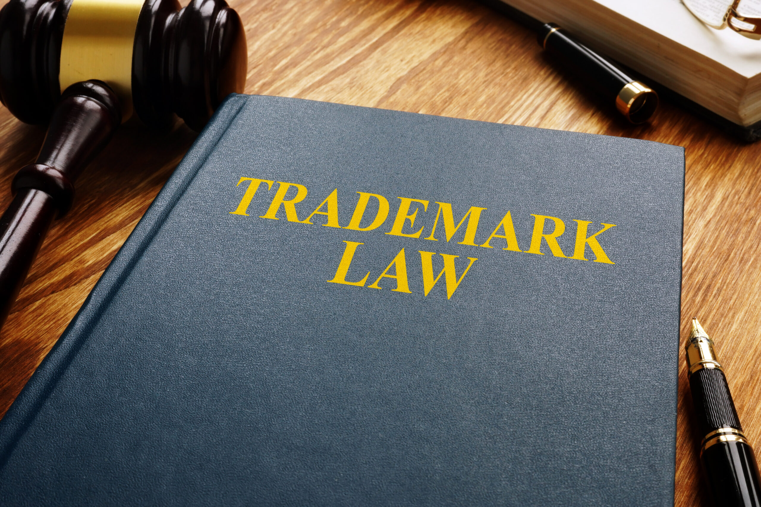 Trademark law and gavel on a wooden surface. Copyright concept.
