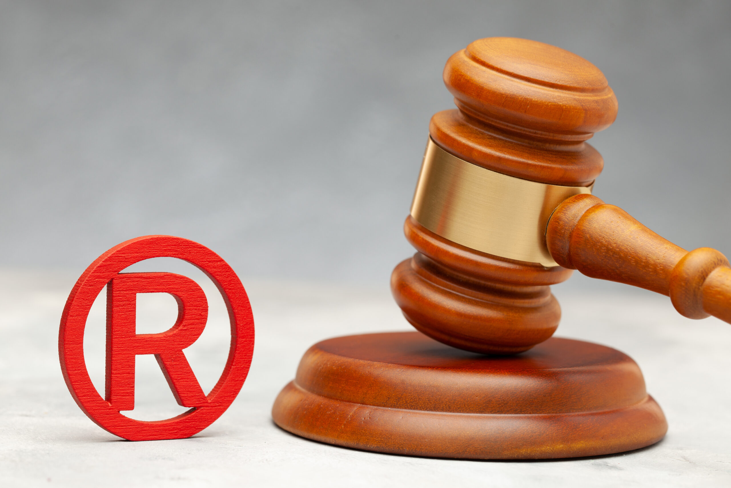 Judge gavel and red trademark sign.